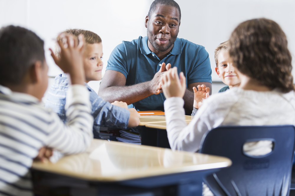 male teacher with kids nearby.jpg